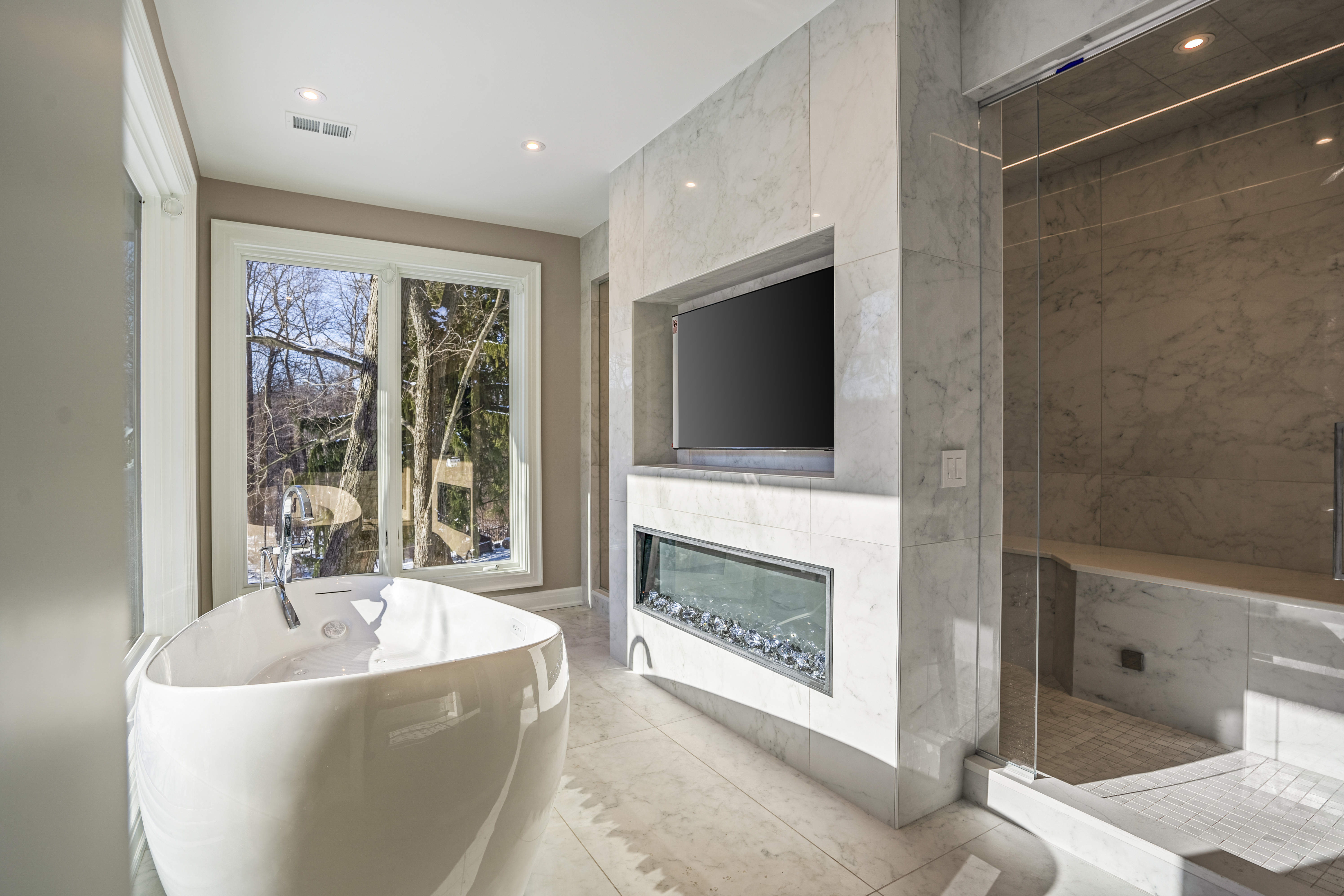 Luxury master bathroom with fireplace and soaking tub